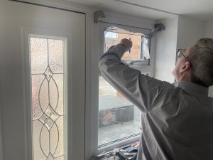 Professional At Work Installing Privacy Film To Inside Of Window