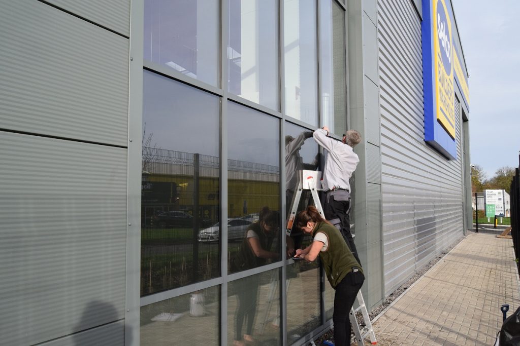 External window film being installed