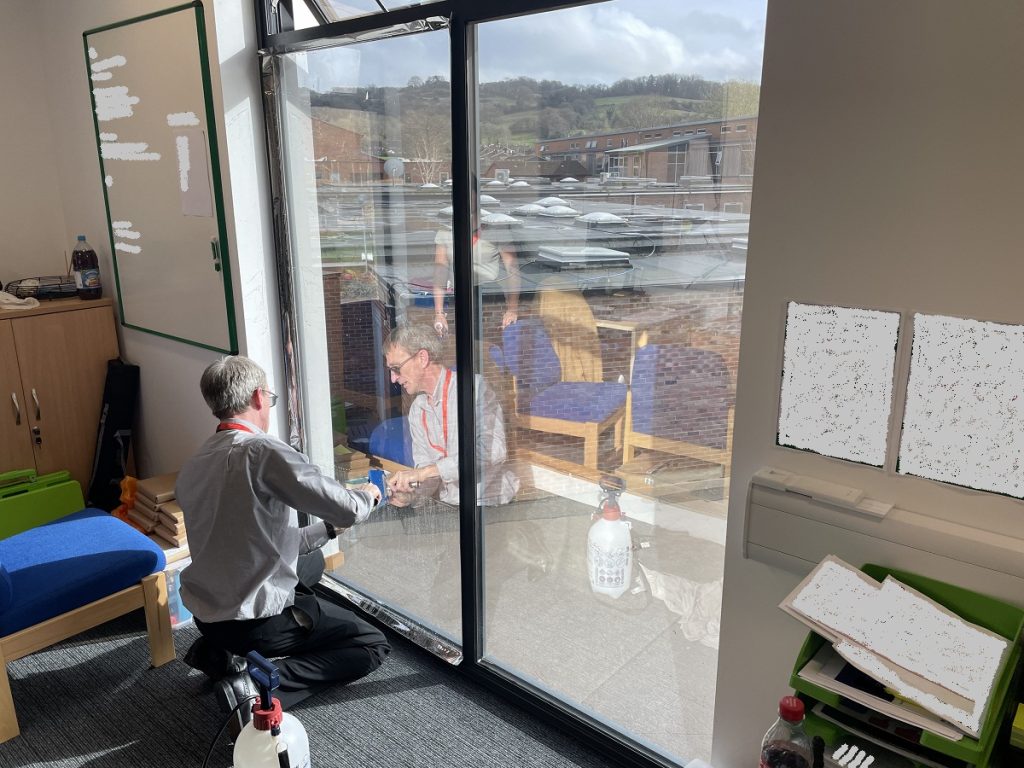 Skilled installer applying window film to window