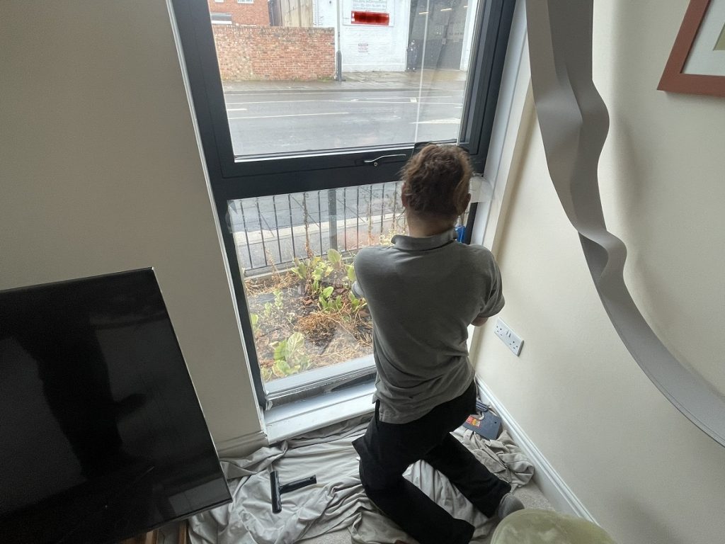 Ground floor flat window film installation in progress alternate view