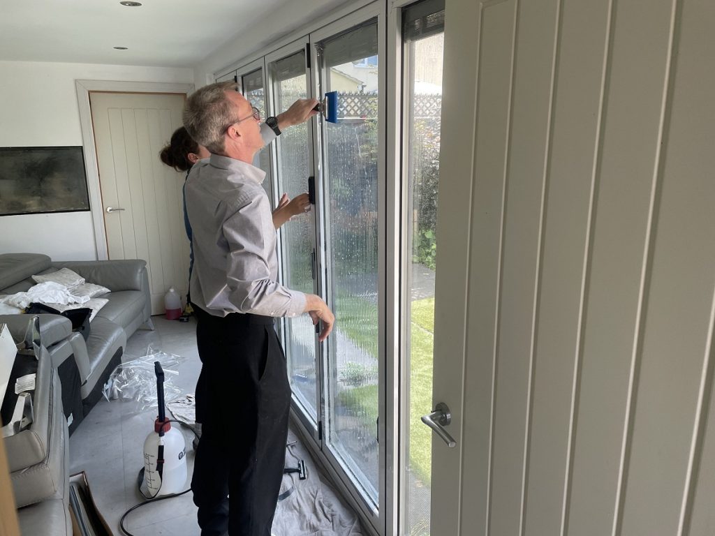 Heat reduction window film being applied to summerhouse