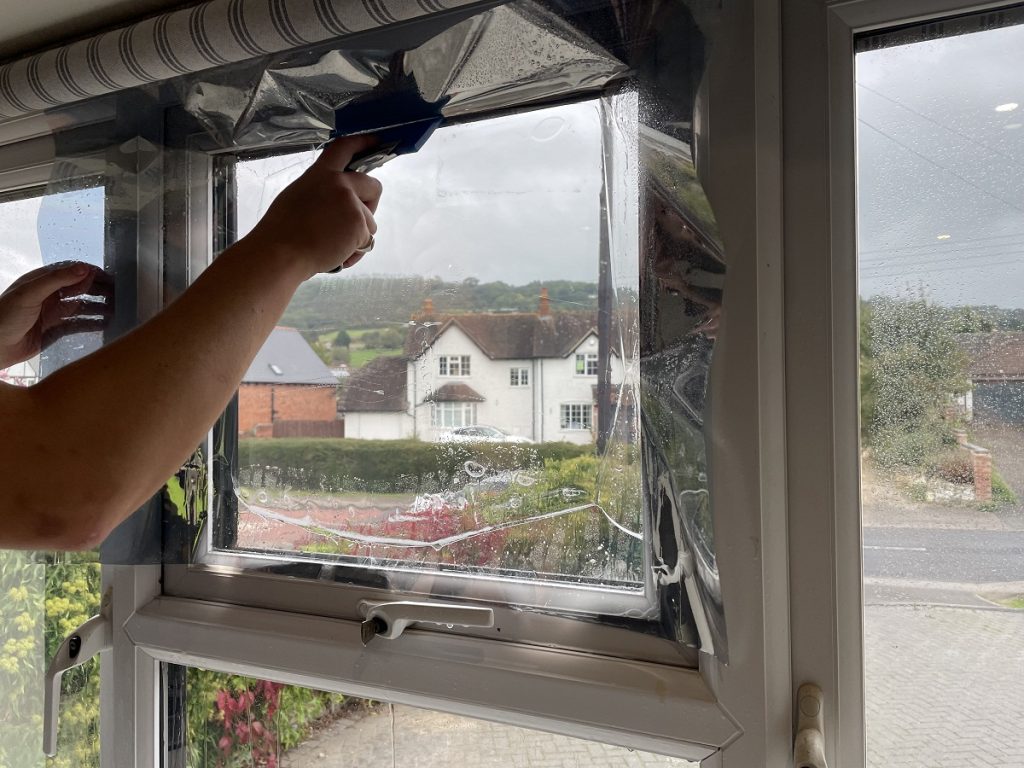 Window film being applied to a small window